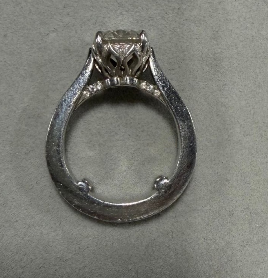 Platinum Round Brilliant Solitaire with Diamond Pavé Shoulders and Ornate Cathedral Setting