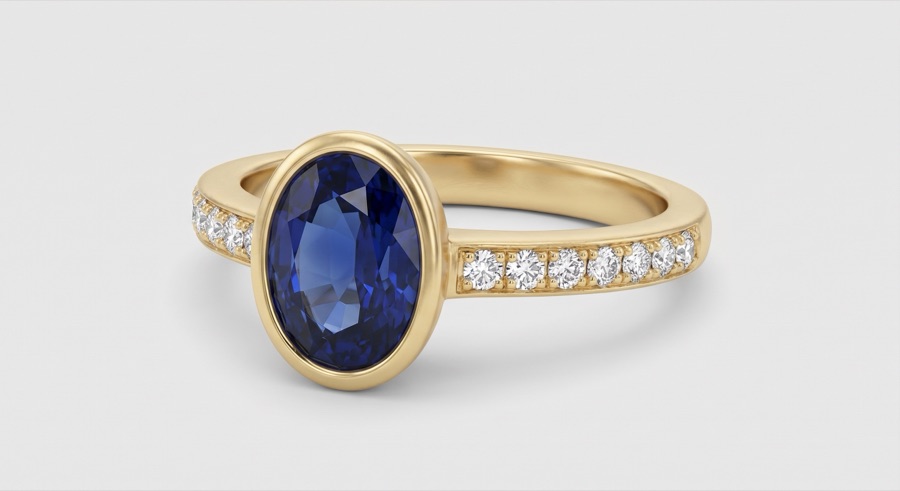 Oval Blue Sapphire Bezel-Set Solitaire with Diamond Pavé Band in Yellow Gold
